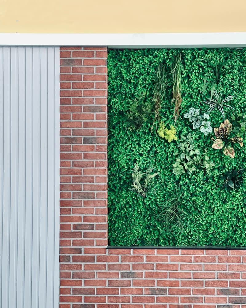 Brick facade with lush green wall panel