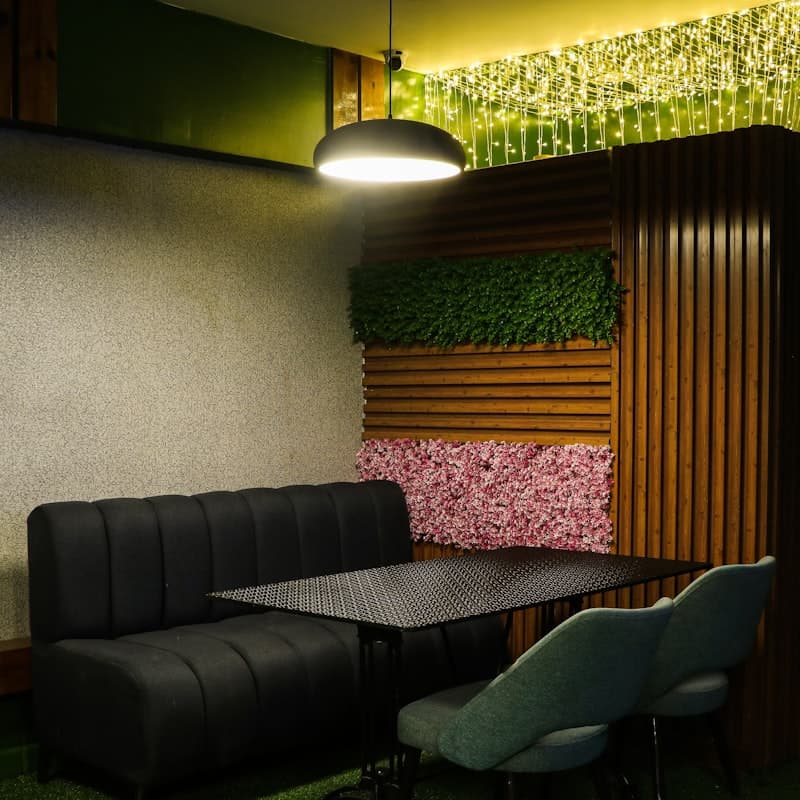 Intimate dining nook — fairy lights and moss panels